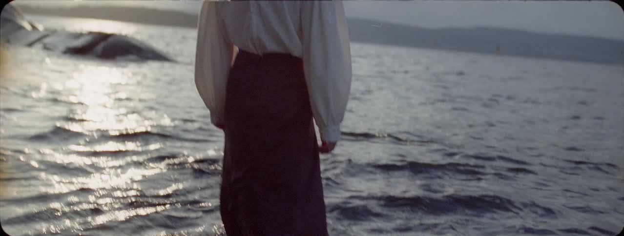 Fully clothed woman walks in a lake