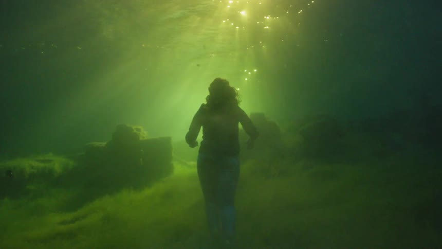 Woman walking underwater