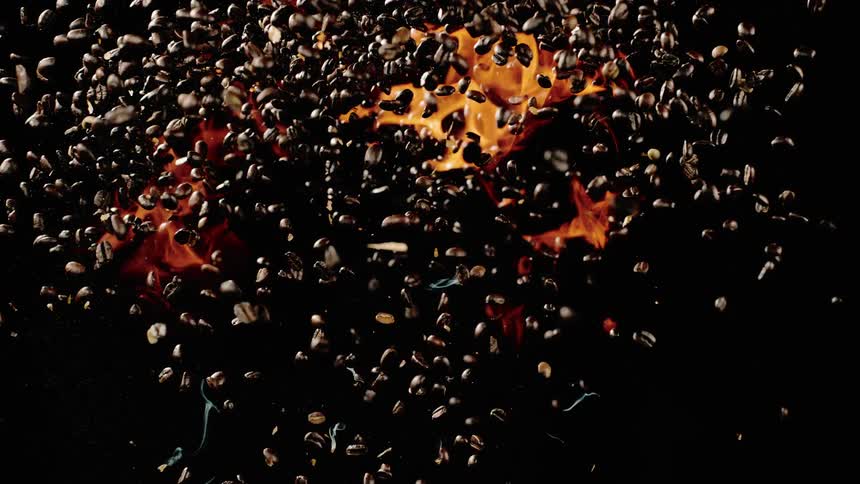 The coffee beans shoot into the air with fire below it