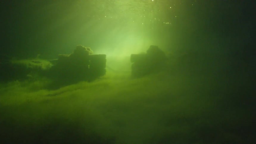 Sunlight shines through dirty lake water