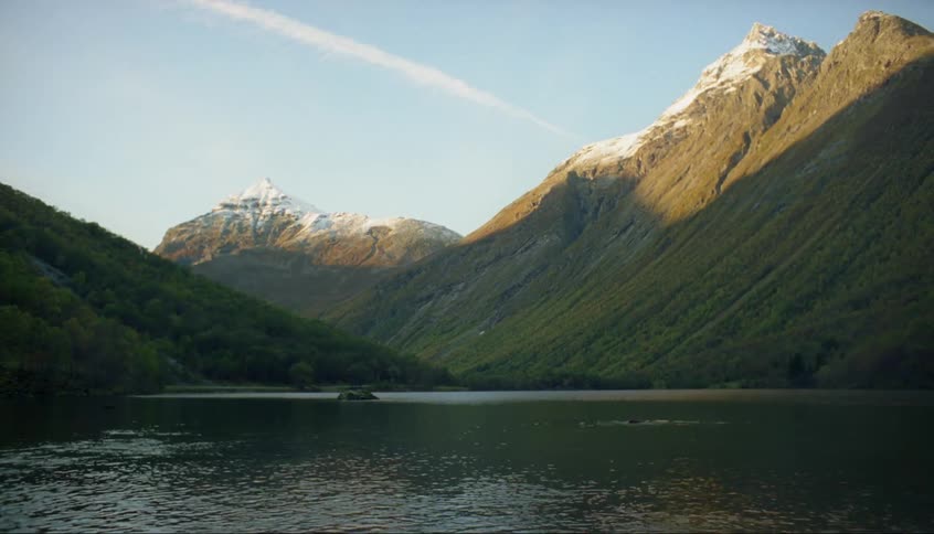 A person dives into the water of the lake ahead