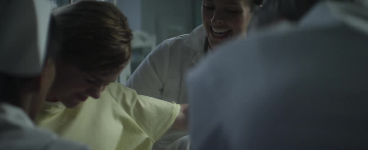 Woman patient being helped by nurses and doctor