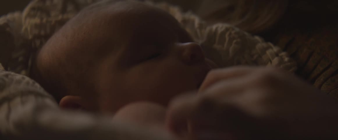 A baby wrapped in a blanket
