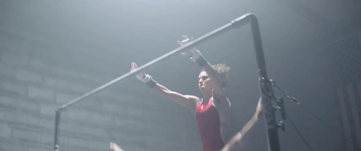 A woman is performing gymnastics in the gym