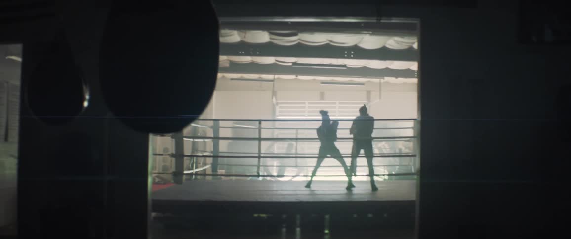 Two people battle it out boxing in the ring