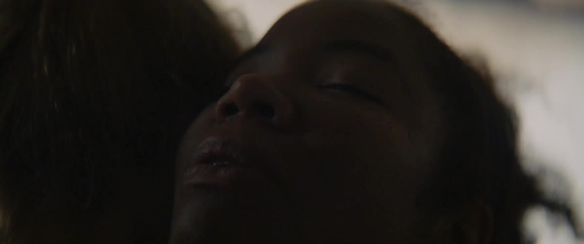 Two people are hugging in the dark