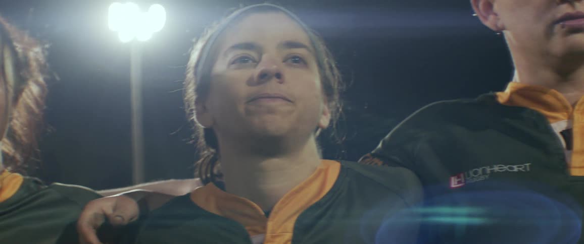 Soccer players stand in stadium listening