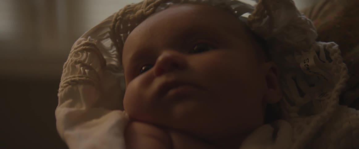 A woman holds an infant