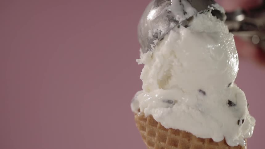 Scoop being lifted from top of ice cream cone