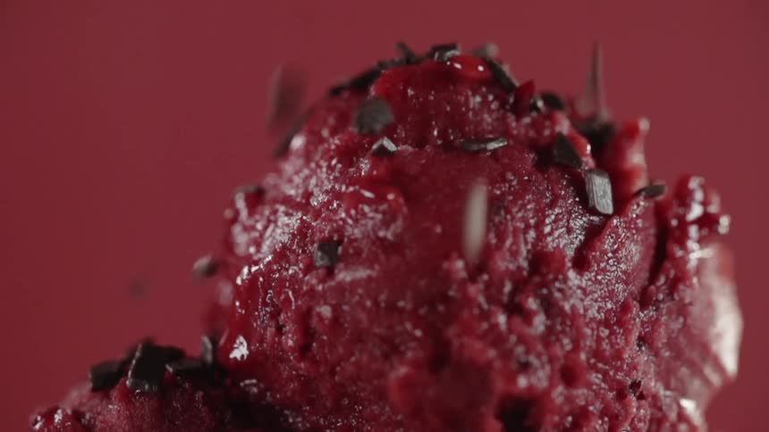 Chocolate sprinkles are poured on ice cream