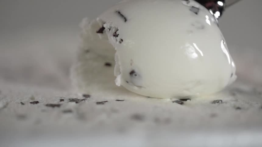 Ice cream is being scooped from the container