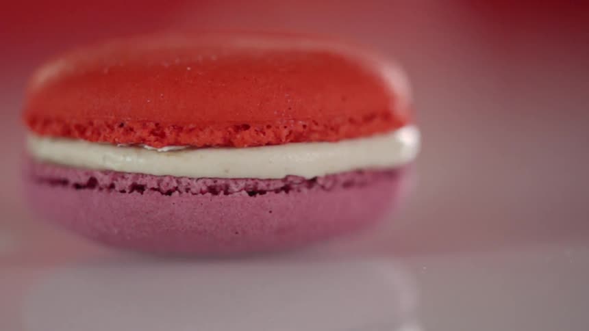 Red and purple macaron with white cream in the middle