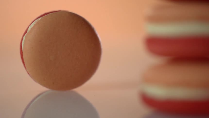 The macaron is standing on its side spinning