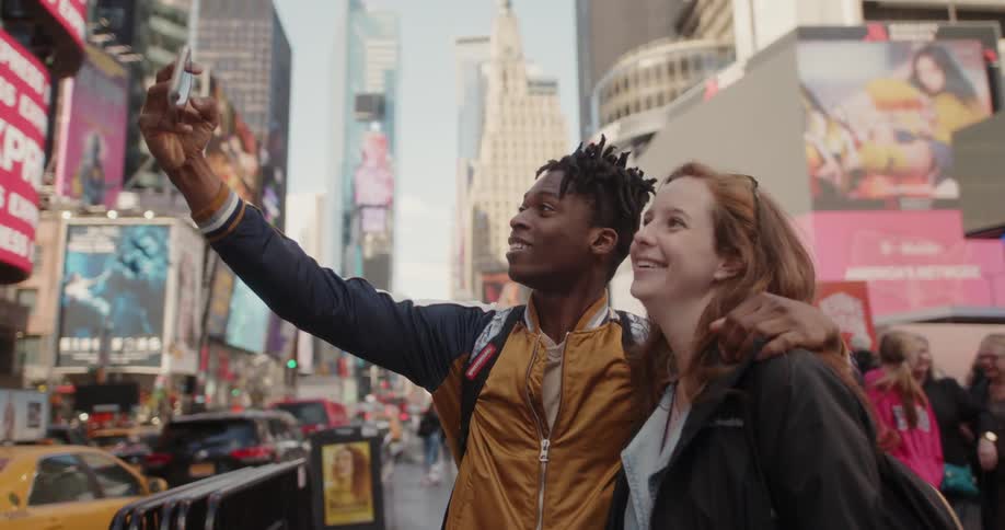 A man takes a selfie with a girl in the city