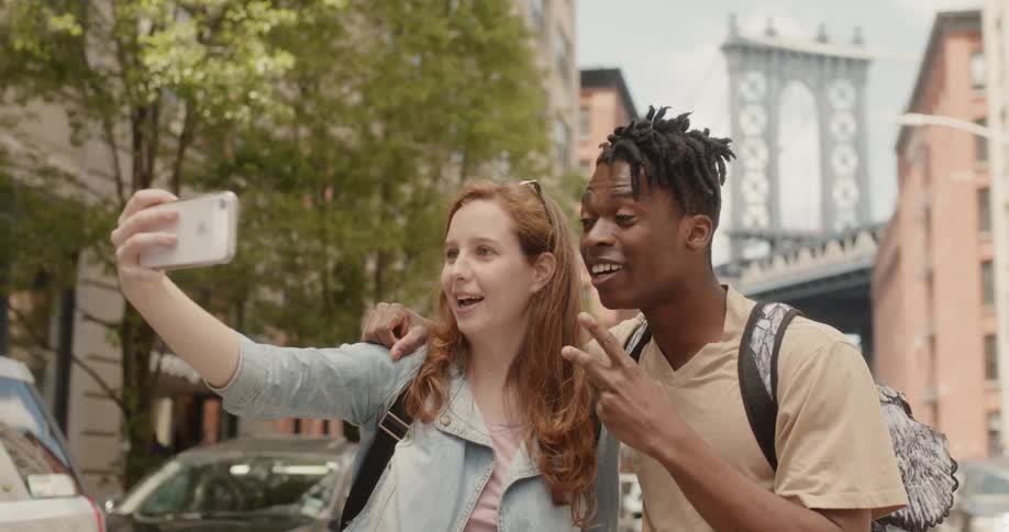 A woman takes a selfie with a man