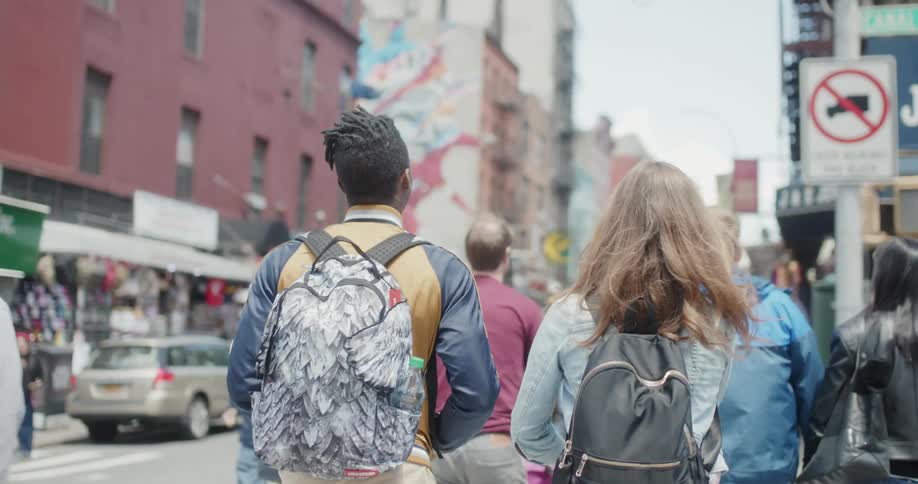 People walk in the city together on a sunny day