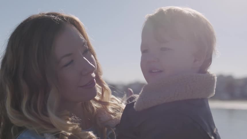 A woman holds her child in her arms