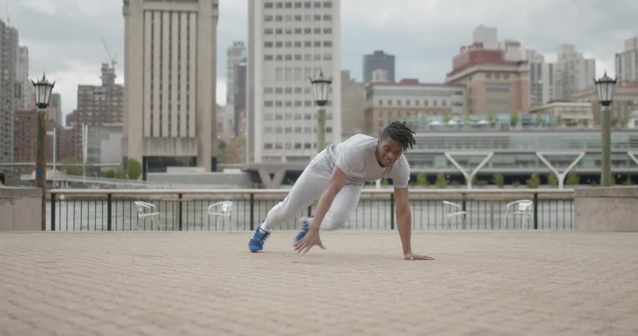 The man is breakdancing in the city