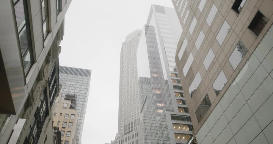 The tall buildings have heavy clouds above