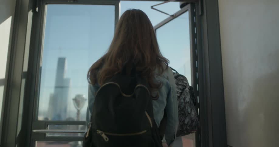 Two people walk out the glass door until the terrace
