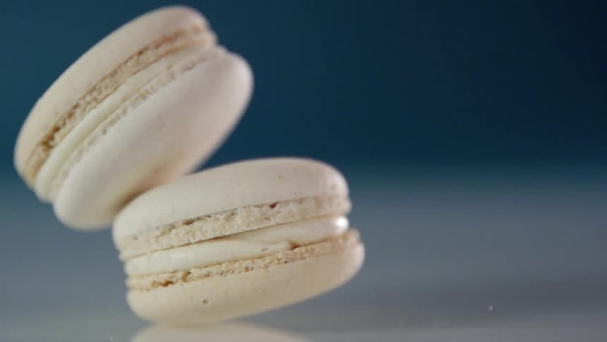 One macaroon falls on top of another macaroon