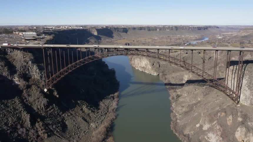 The bridge has many cars crossing both ways
