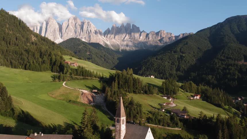 Breathtaking mountain range lies beneath a small village
