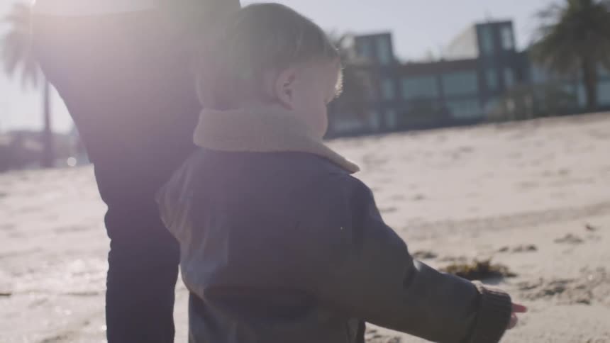 A man and young child walk together