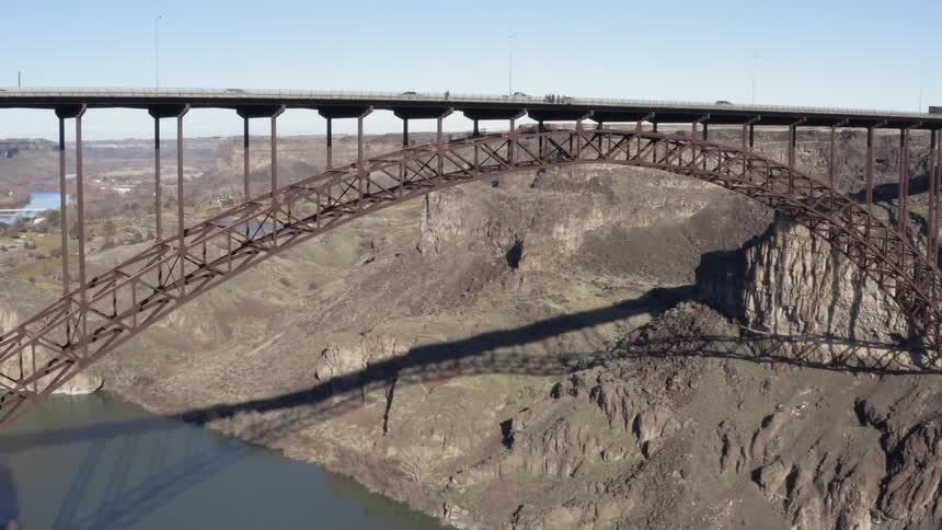 The long bridge has many cars traveling over
