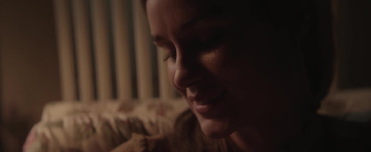 A woman smiles and coos at someone