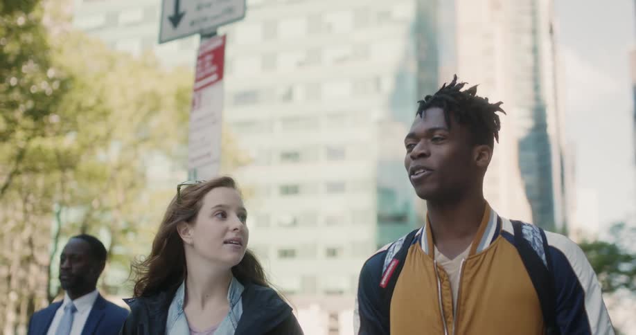 A man and woman walk together in the city