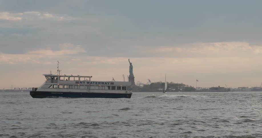 The ferry transports people past the statue of liberty