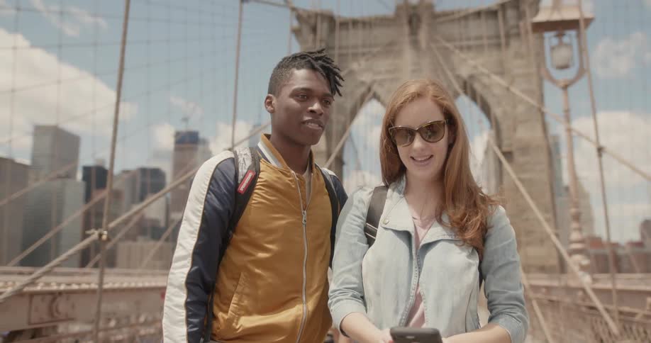 Man and woman take a picture of themselves on a bridge
