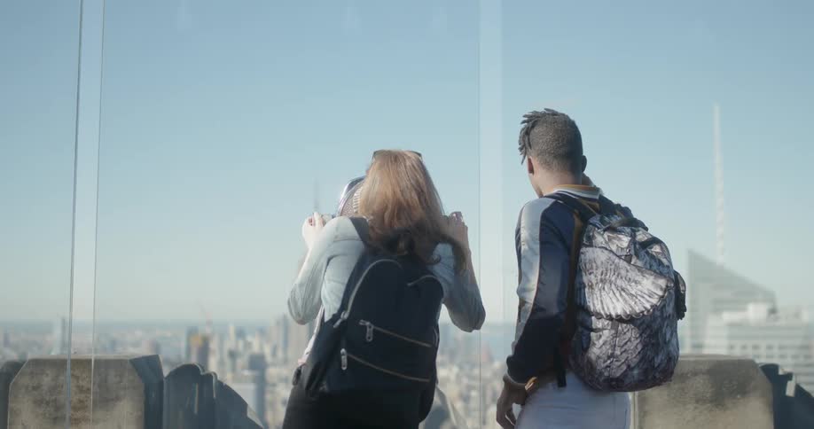 A man and woman stand at a lookout tower together