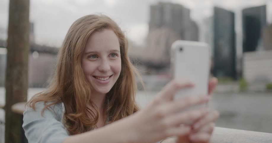 A woman takes a photo with her cell phone