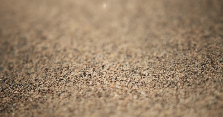 Grains of sand bounce on the ground