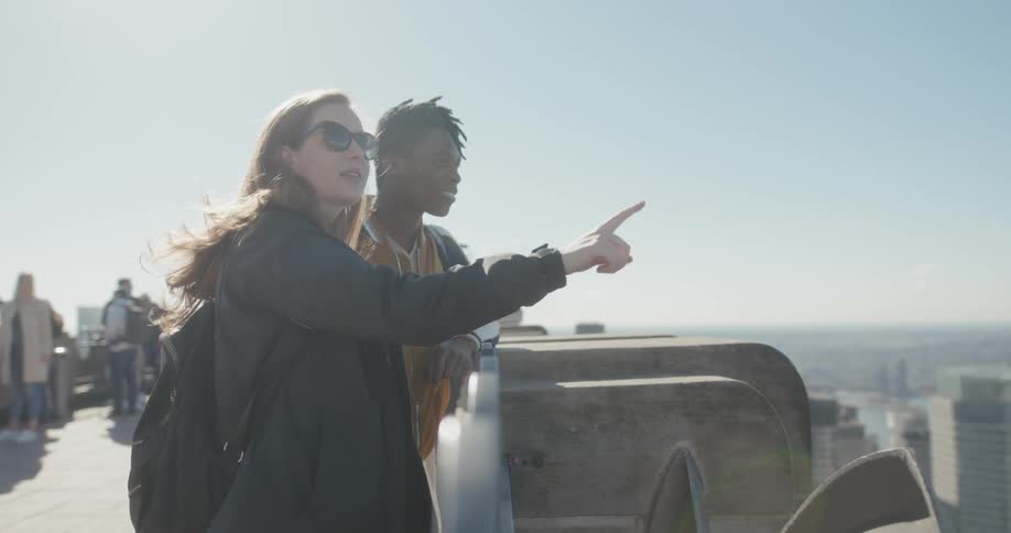 Man and woman sightseeing in a city on a sunny day