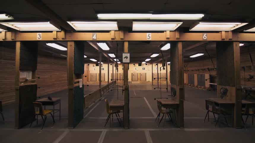 The lights turn on in the empty firing range