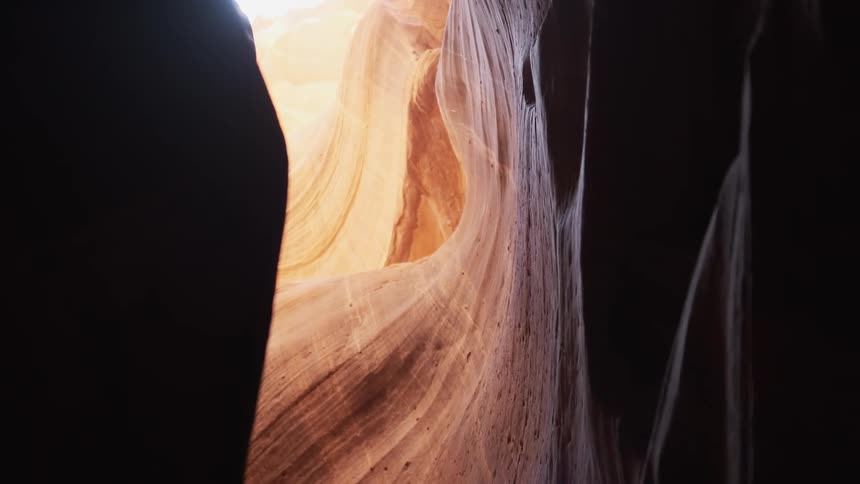 The tunnel is dark with sunlight at the end