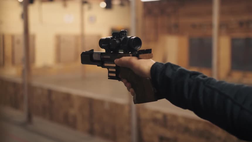 Person practices shooting at a firing range
