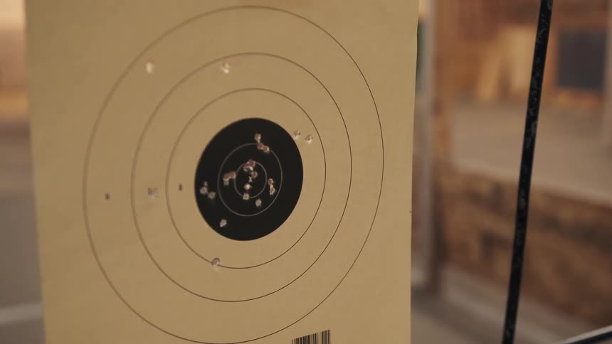 The target is covered with bullet holes