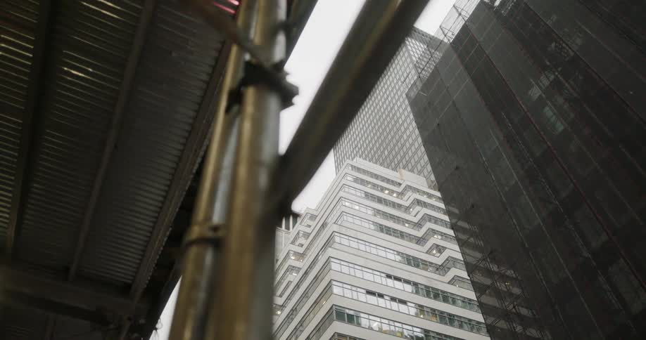 The tall buildings cover the street across the way