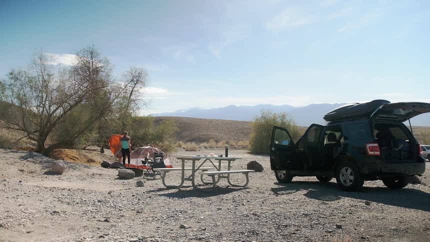 Time lapse of campers setting up a tent