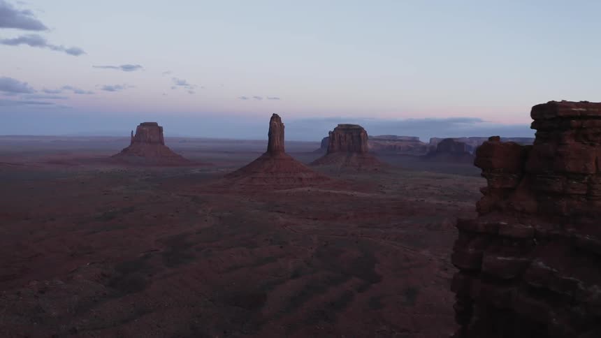 Aerial view through desert mountains at dusk