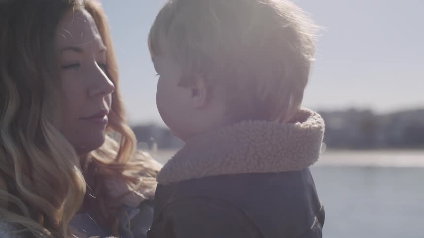 Family At Beach With Their Toddler