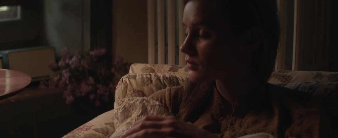A woman holding an infant in a blanket