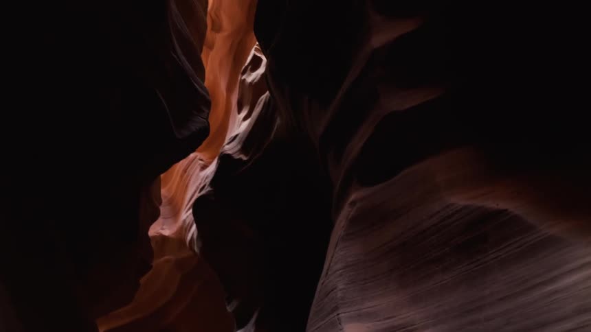 The dark cave has sun coming in from the roof
