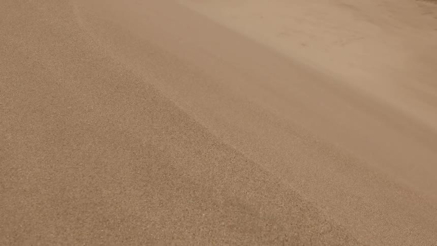 Macro shot of sand particles blowing in the wind