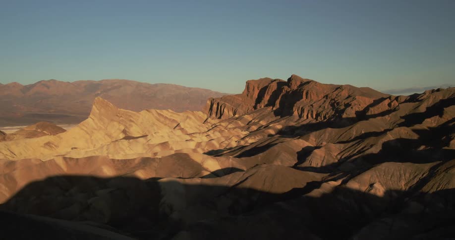 The sun shines on the layered canyon
