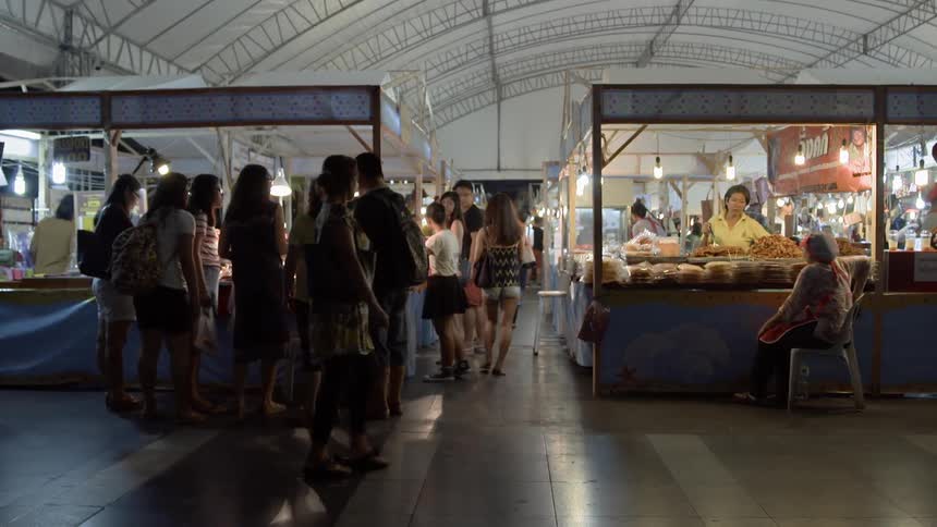 Crowd of people shop in an indoor market